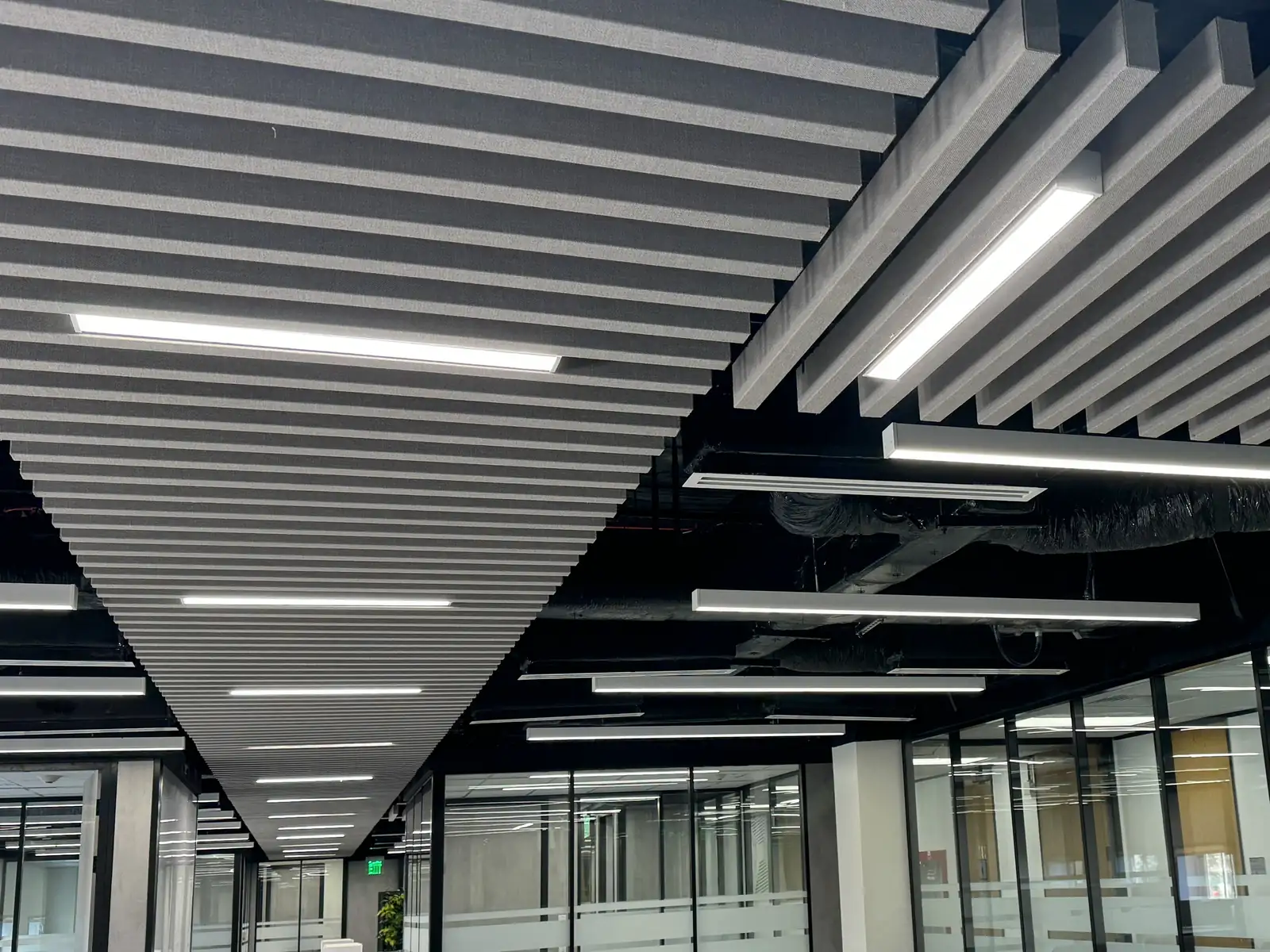 Acoustic baffle ceiling over an open-plan office