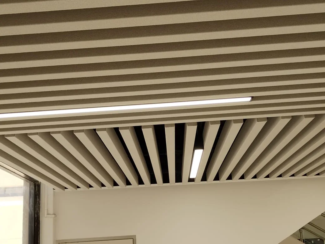 Fabric-wrapped baffles running in two directions, with linear lights set into the runs