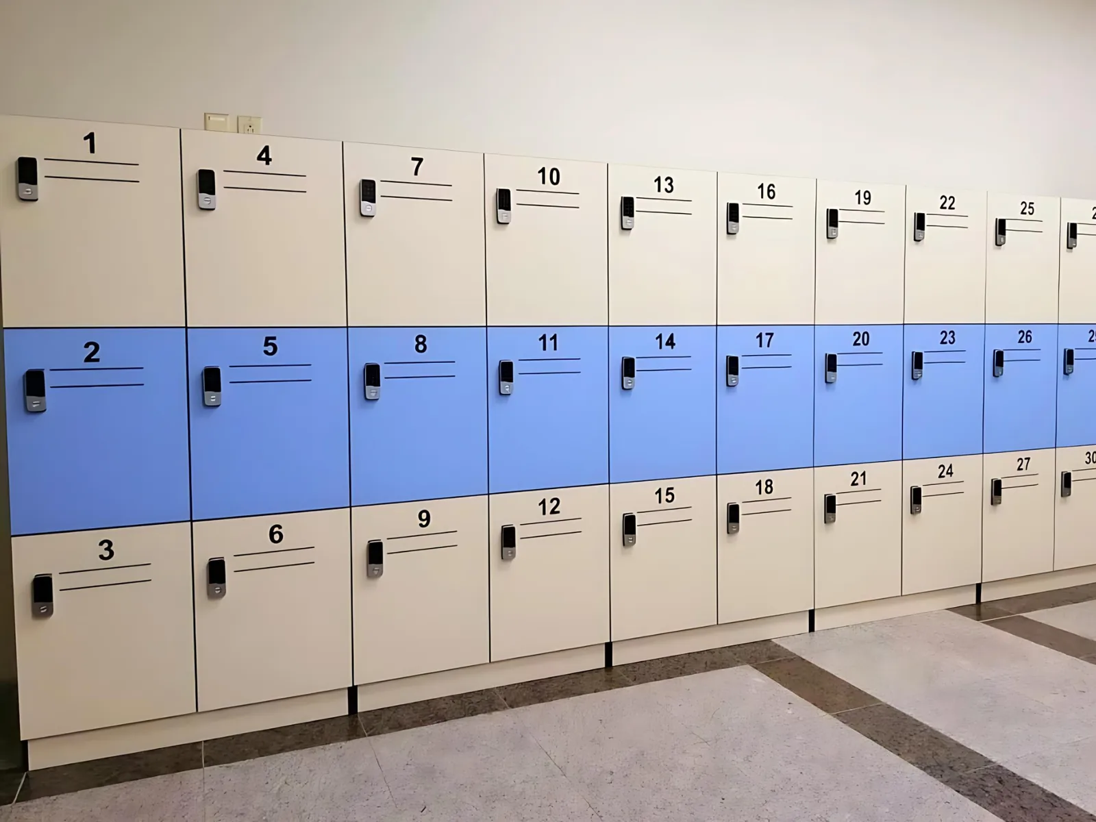 Three-tier changing-room locker bank in beige with a blue middle row, numbered doors and keypad locks