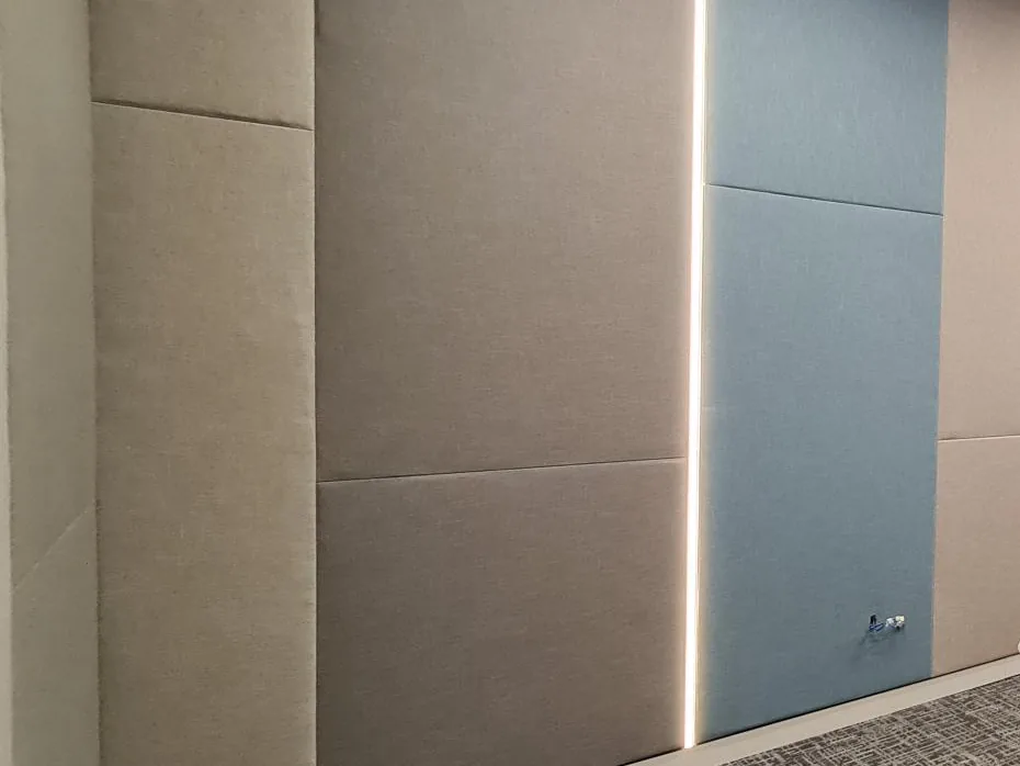 Beige and blue fabric-wrapped panels running floor to ceiling, separated by a vertical strip of light