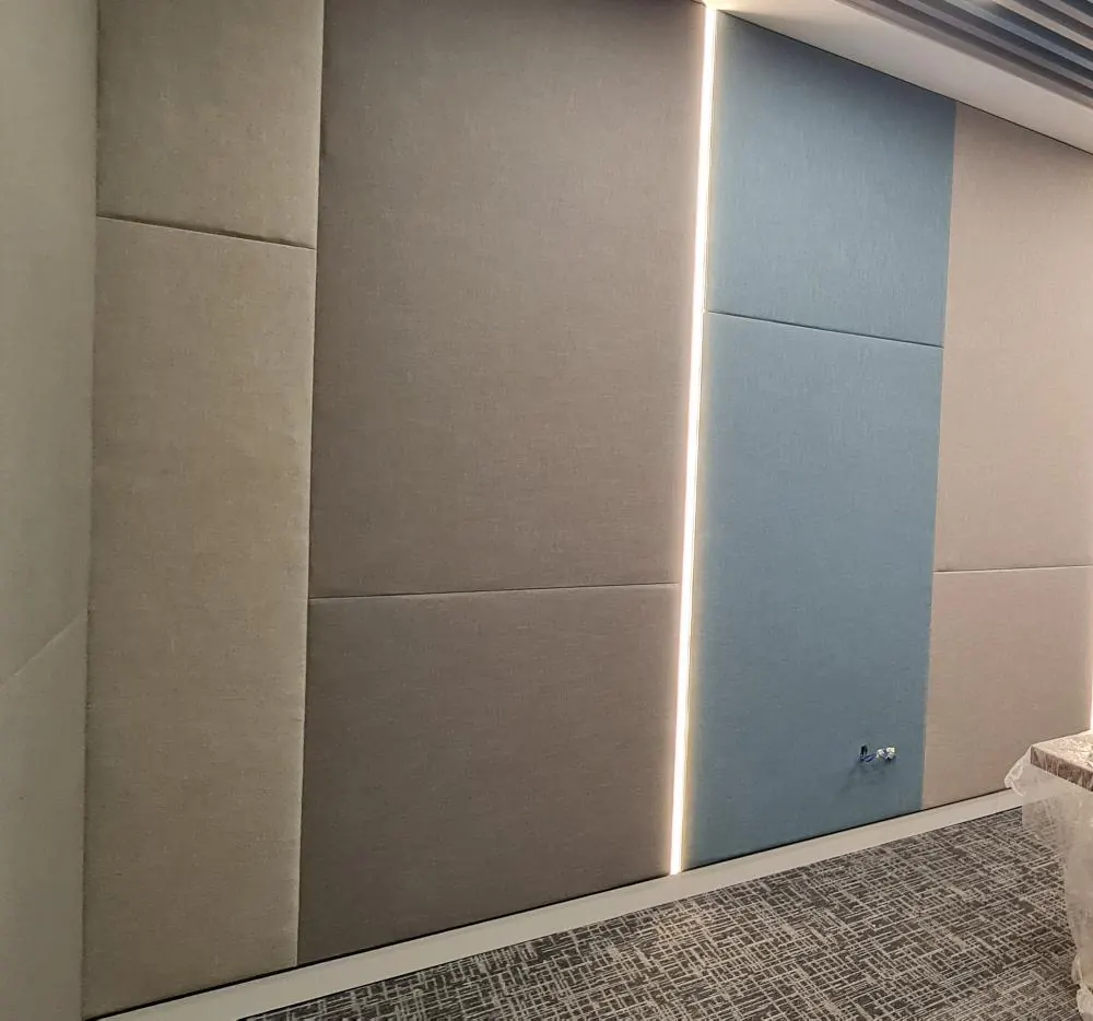 Close view of fabric-wrapped acoustic wall panels and the joints between them