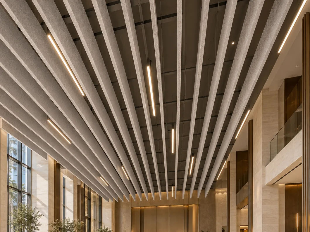 Double-height lobby under closely spaced light-grey fabric baffles with slim linear lights between them