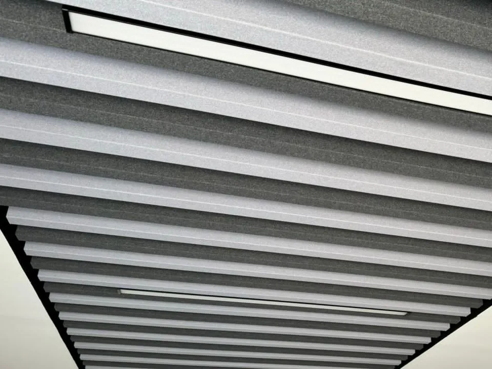 Island of alternating light-grey and charcoal baffles with linear lights set between the blades