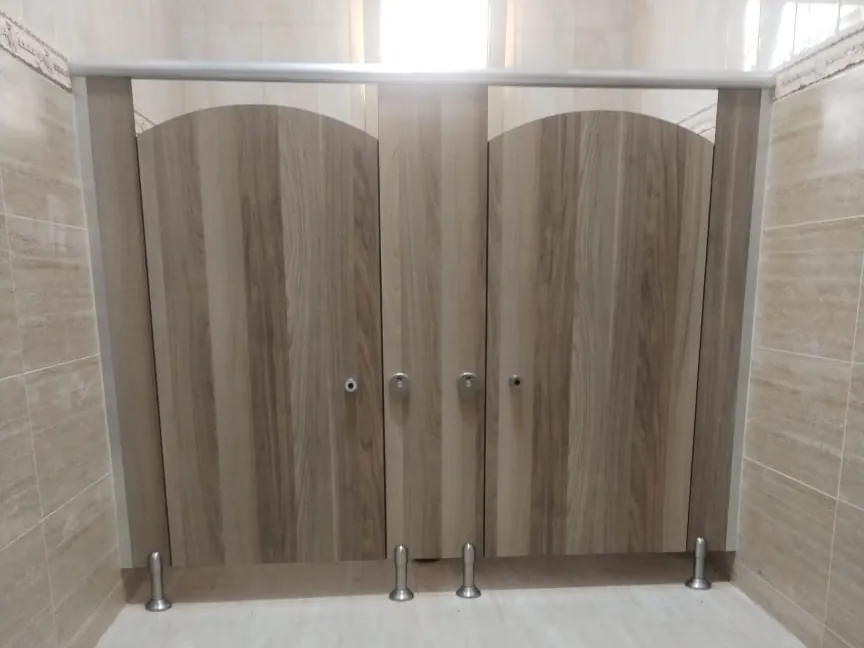 Two wood-grain cubicles with arched door tops under a headrail