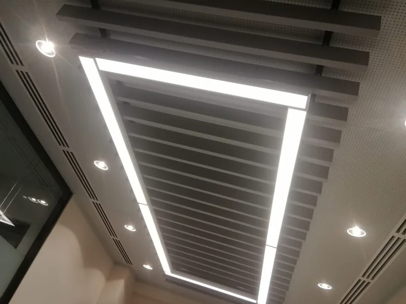 Feature baffle ceiling framed by a rectangular LED line